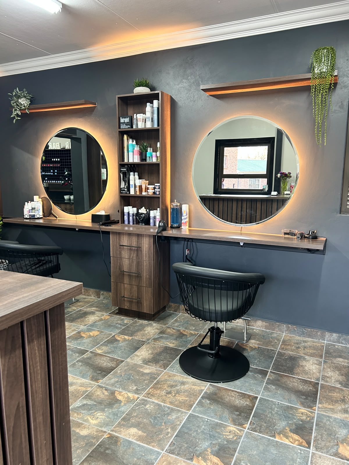 Bloom & Brush Hair Studio styling stations with round illuminated mirrors and professional hair products
